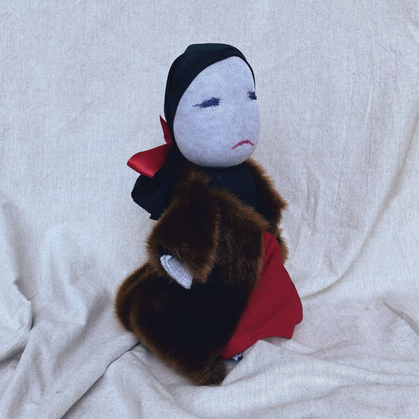 Side view of Little Edie Doll in her fur coat and black scarf