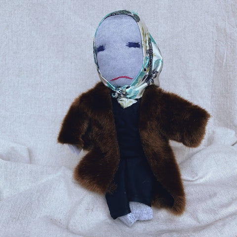 Little Edie Doll in her fur coat and blue printed scarf