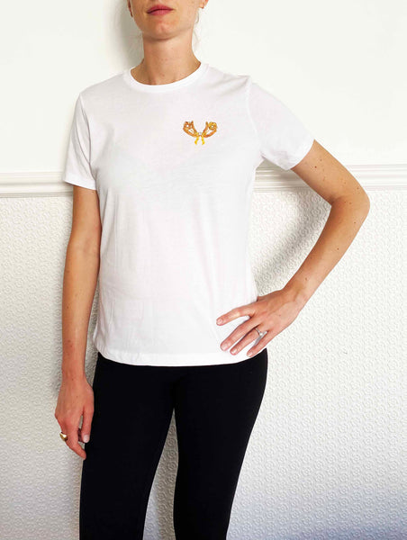 white short sleeved tee shirt with brooch art printed on